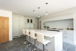 white-fitted-kitchen-renovation-with-stools-at-breakfast-bar